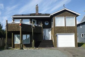 Two-story wooden-shingled house near the beach