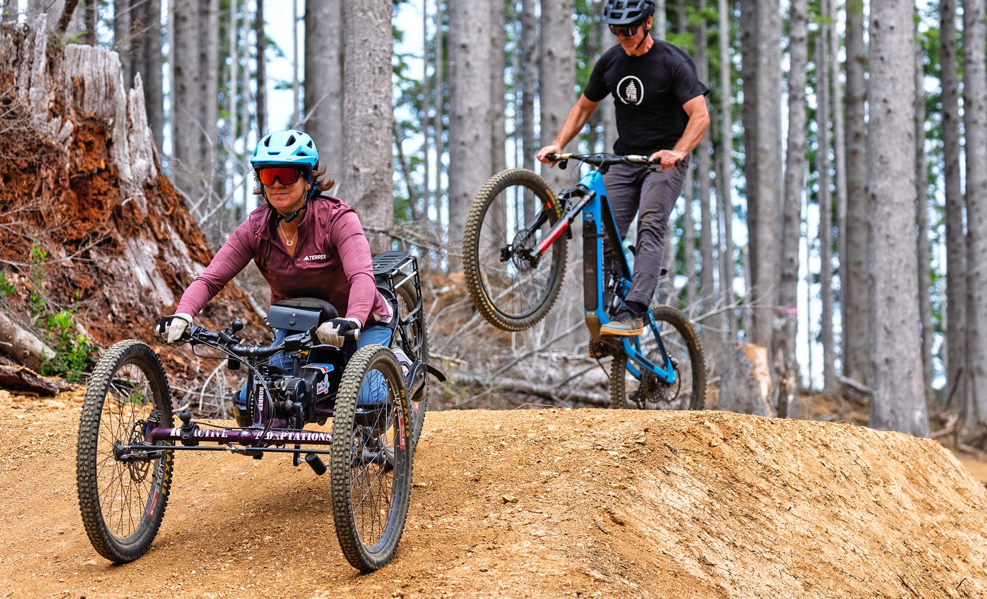 banner adaptive mountain biking recumbent trike rider jump dirt trail forest by benmoon